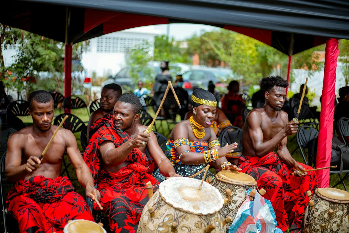 A group of African musicians playing traditional hand drums together